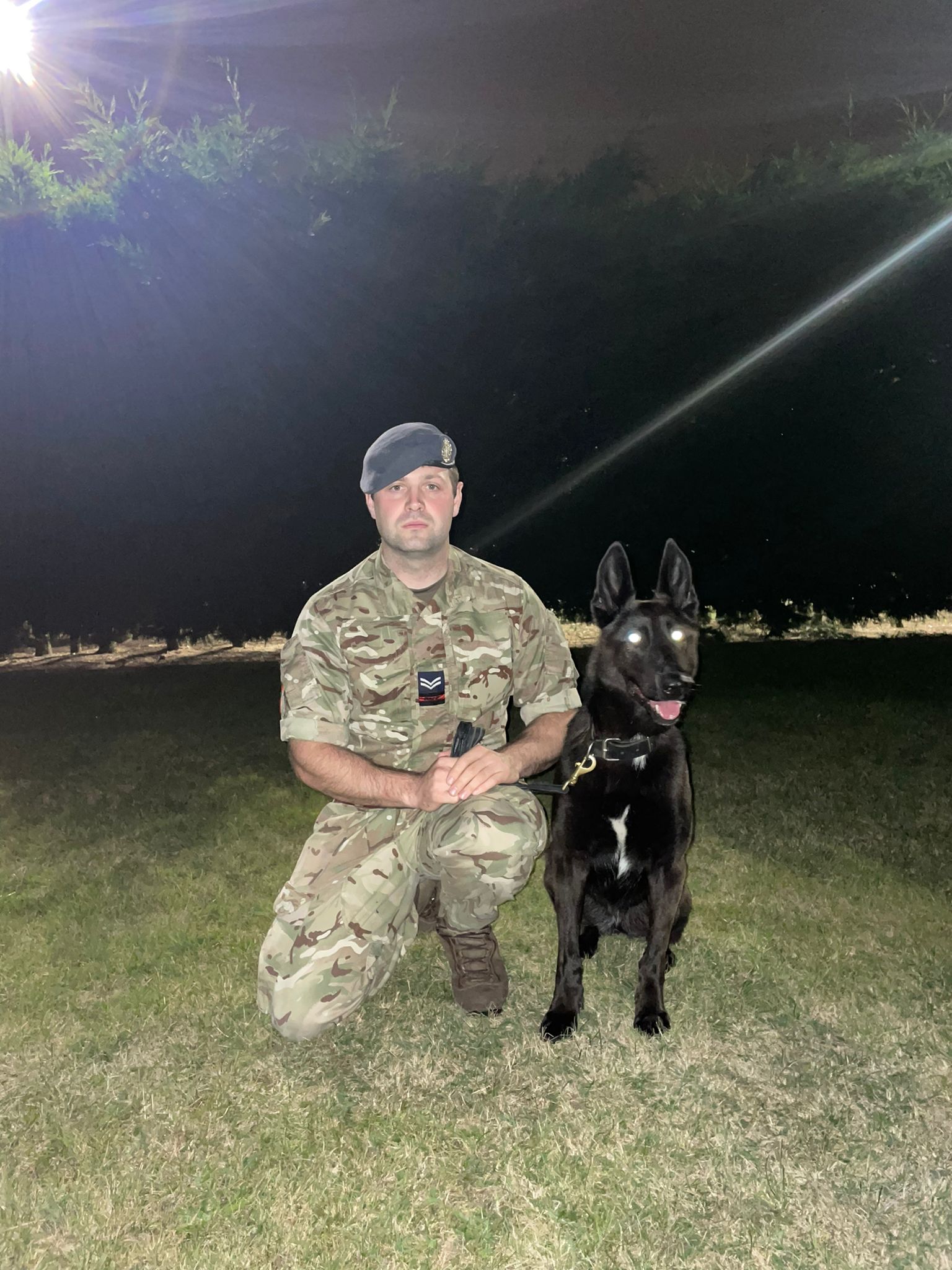 RAF Police Handler and dog at night.
